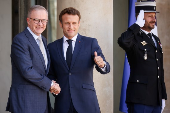 Macron and Albanese shake hands