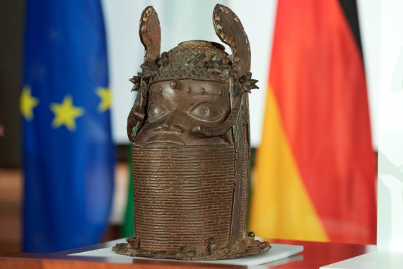 A Benin Bronze sculpture is presented at the German Foreign Ministry prior to the signing ceremony of a joint declaration between Germany and Nigeria in Berlin, Germany on July 1, 2022. Germany and Nigeria signed an agreement in Berlin Friday paving the way for the return of centuries-old sculptures known as the Benin Bronzes that were taken from Africa in the 19th century and displayed in German museums and elsewhere [Markus Schreiber/AP]