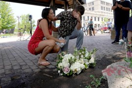 Mourners at a memorial for the victims of a July 4 mass shooting in Illinois, where the Highland Park suspected attacker appeared before a judge Wednesday [Charles Rex Arbogast/AP Photo]