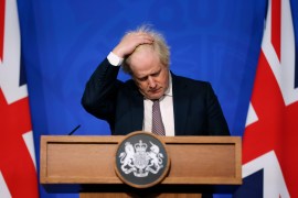 Johnson gestures as he speaks during a press conference in London [File: Hollie Adams/Pool via AP]