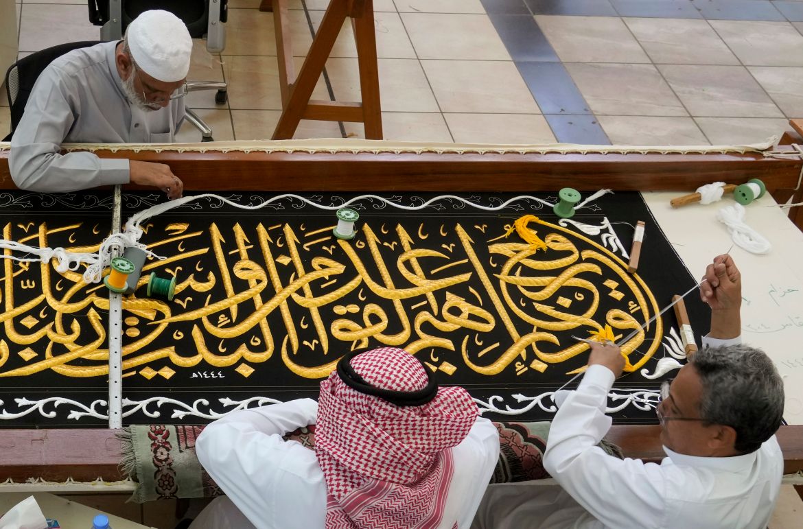 Saudi workers embroider Islamic calligraphy using either pure silver threads or silver threads plated with gold during the final stages in the preparation of a drape, or Kiswa, that covers the Kaaba