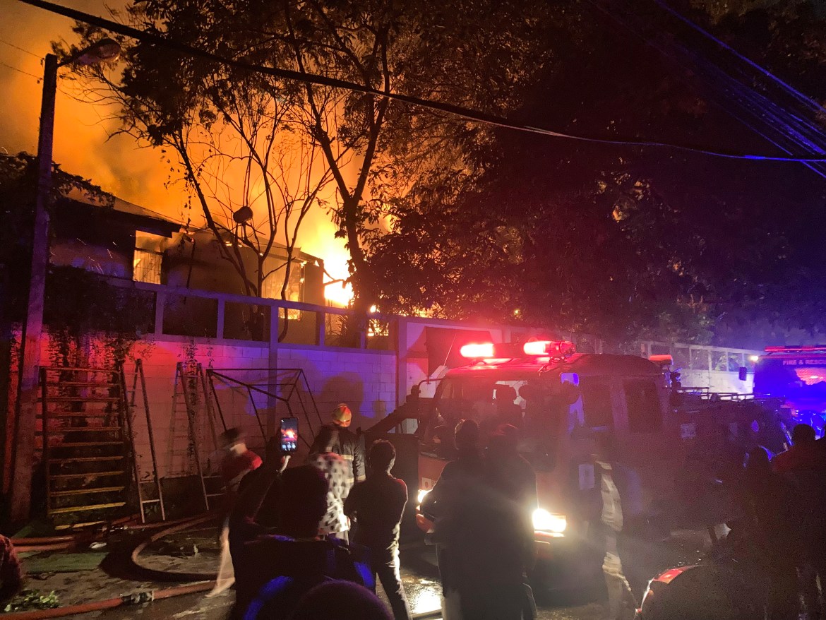 Firefighters try to douse a fire at the Sri Lankan prime minister Ranil Wickremesinghe's private residence