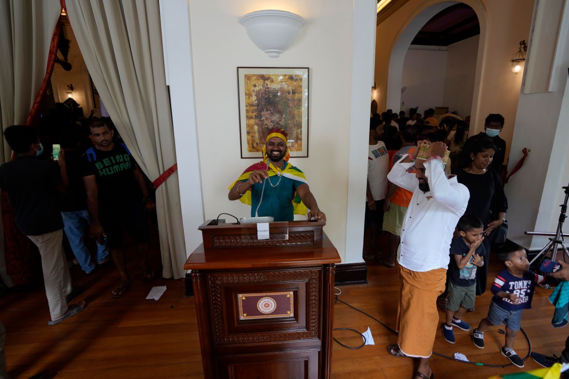 A protester pretends a address the nation using a podium at president's official residence