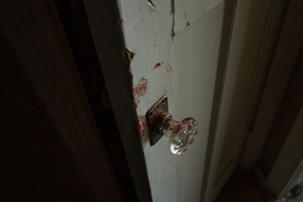 Blood stains on a door in the hallway of the apartment of 66-year-old Volodymyr,
