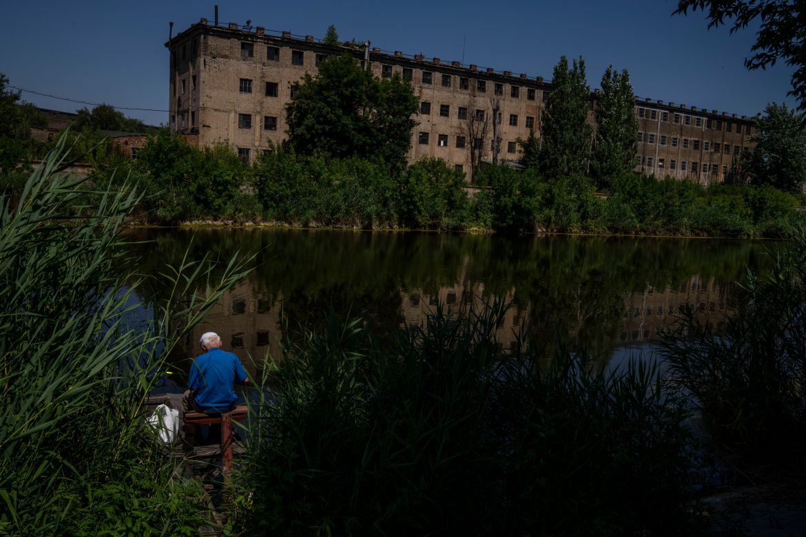 A fisherman resident who refuses to evacuate his hometown, fishes by the river, in Kramatorsk, eastern Ukraine