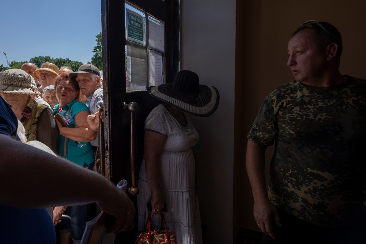 People who mostly refuse to evacuate their homes, wait in line to receive humanitarian food aid from the Kramatorsk city