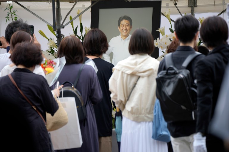 People line up to offer flowers and pray to Shinzo Abe who was killed on Friday