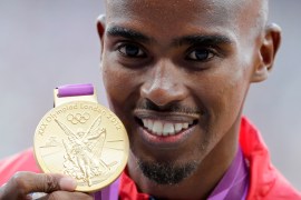 Britain's Mo Farah poses with his gold medal