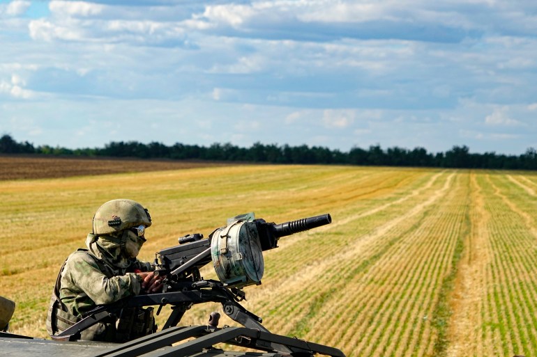 A Russian soldier is seen atop of a military truck