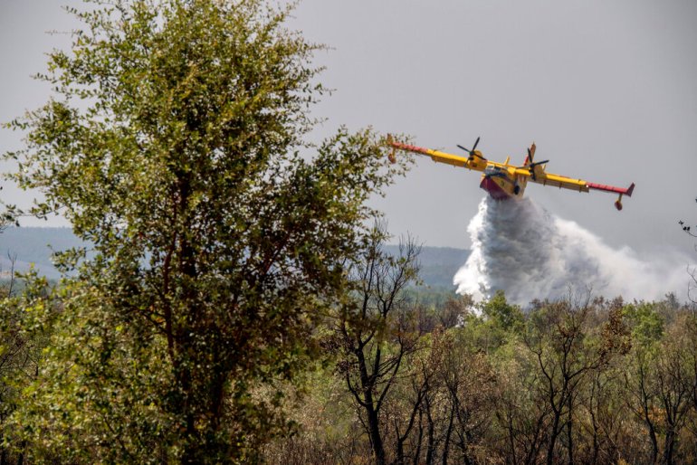 Fire fighting planes drop water