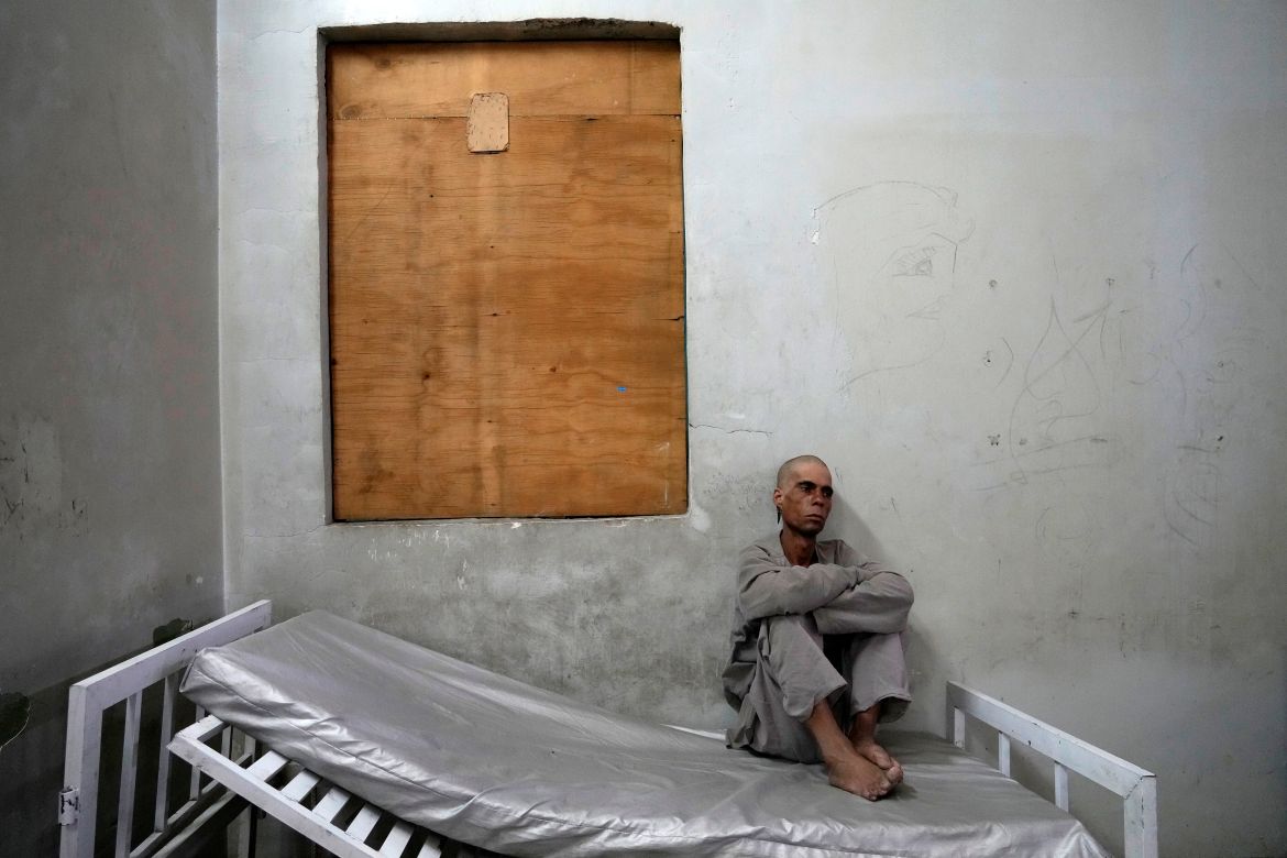 A drug addict sits on his bed in the detoxification ward