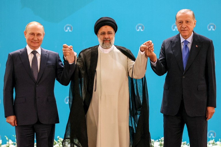 Russian President Vladimir Putin, Iranian President Ebrahim Raisi and Turkish President Recep Tayyip Erdogan pose for a photo in Tehran, Iran