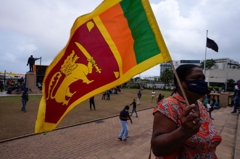 A protestor holds Sri Lankan flag outside president's office in Colombo, Sri Lanka