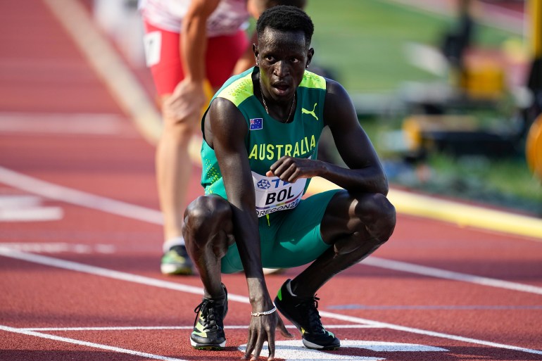 Australia's Peter Bol squats on the track to catch his breath after a heat at the World Athletics Championships