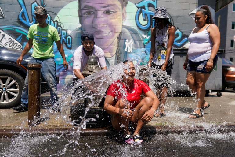 Woman being sprayed by water during heat wave