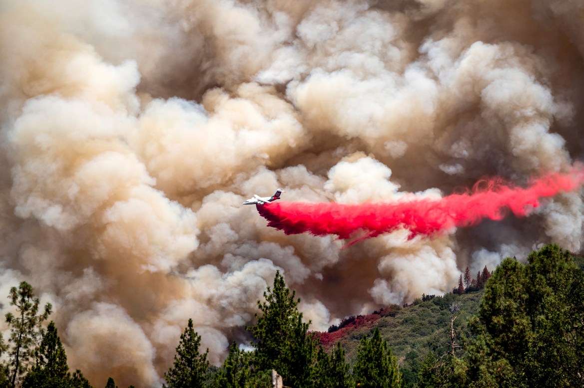 An air tanker drops retardant while trying to stop the Oak Fire from progressing