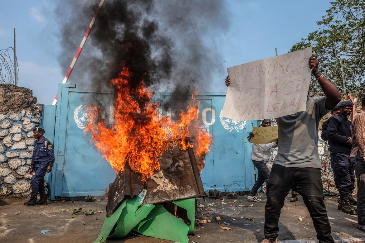 A resident holds a placard reading ''MONUSCO get out without delay'' as they protest against the United Nations peacekeeping force (MONUSCO) deployed in the Democratic Republic of the Congo, in Goma