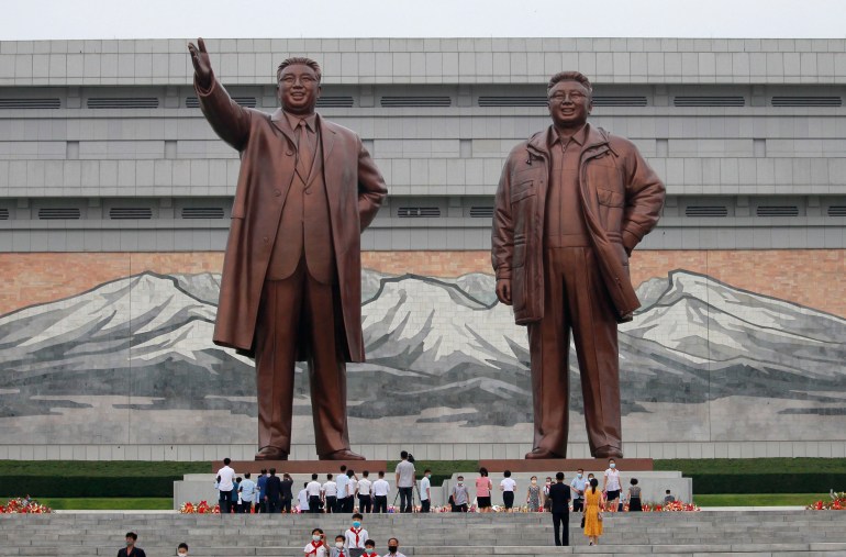 People visit the statues of former North Korean leaders Kim Il Sung and Kim Jong Il.