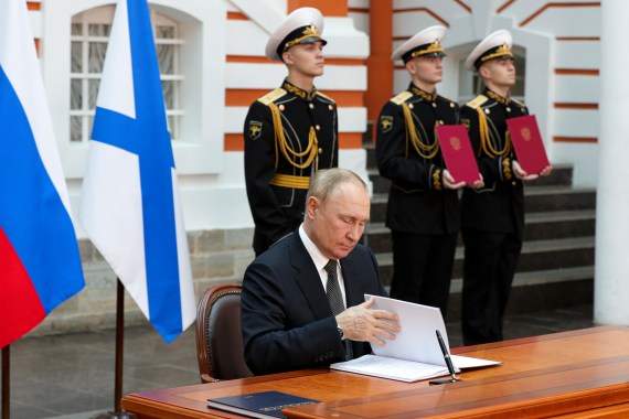 Russian President Vladimir Putin signs the decrees approving the Naval Doctrine and the Ship Charter of the Russian Navy in the St. Petersburg State History Museum at the Peter and Paul Fortress before the main naval parade marking Russian Navy Day