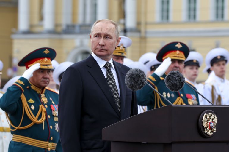 Russian President Vladimir Putin, center, delivers his speech prior to the military parade during Navy Day celebrations on the Neva River, St.Petersburg, Russia, Sunday, July 31, 2022. Russian Defense Minister Sergei Shoigu is on the left. (Mikhail Klimentyev, Sputnik, Kremlin Pool Photo via AP)