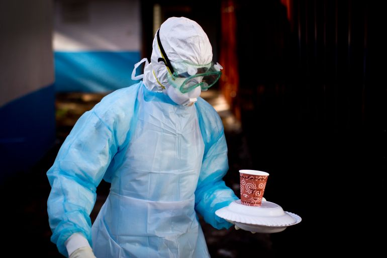 In this Oct. 8, 2014 photo, a medical worker from the Infection Prevention and Control unit wearing full protective equipment carries a meal to an isolation tent housing a man being quarantined after coming into contact in Uganda with a carrier of the Marburg Virus, a hemorrhagic fever from the same family as Ebola, at the Kenyatta National Hospital in Nairobi, Kenya. Health officials battling the Ebola outbreak that has killed more than 4,500 people in West Africa have managed to limit its spread on the continent