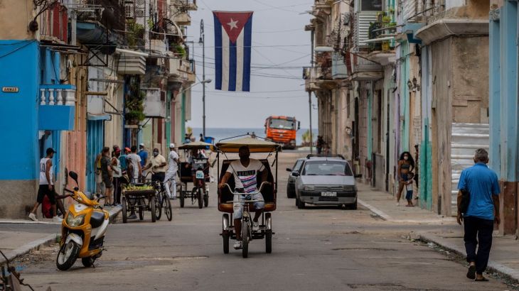 A man rides a pedicab through the streets of Havana, Cuba