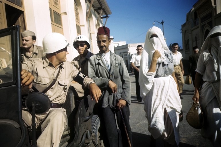 SEPTEMBER 1943: A local man talks with an MP in the Casbah of Algiers, Algeria