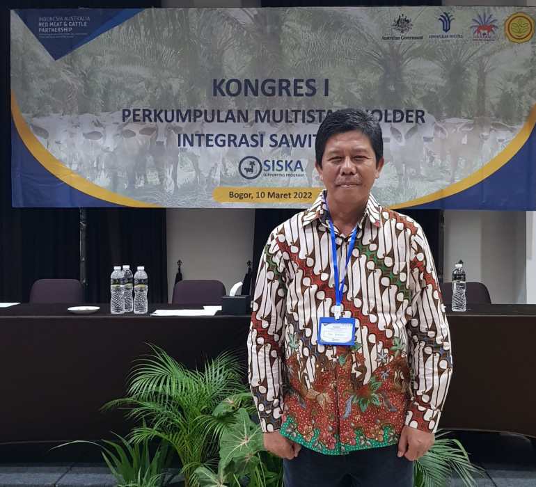 Deddy Kurniawan standing in a meeting room.