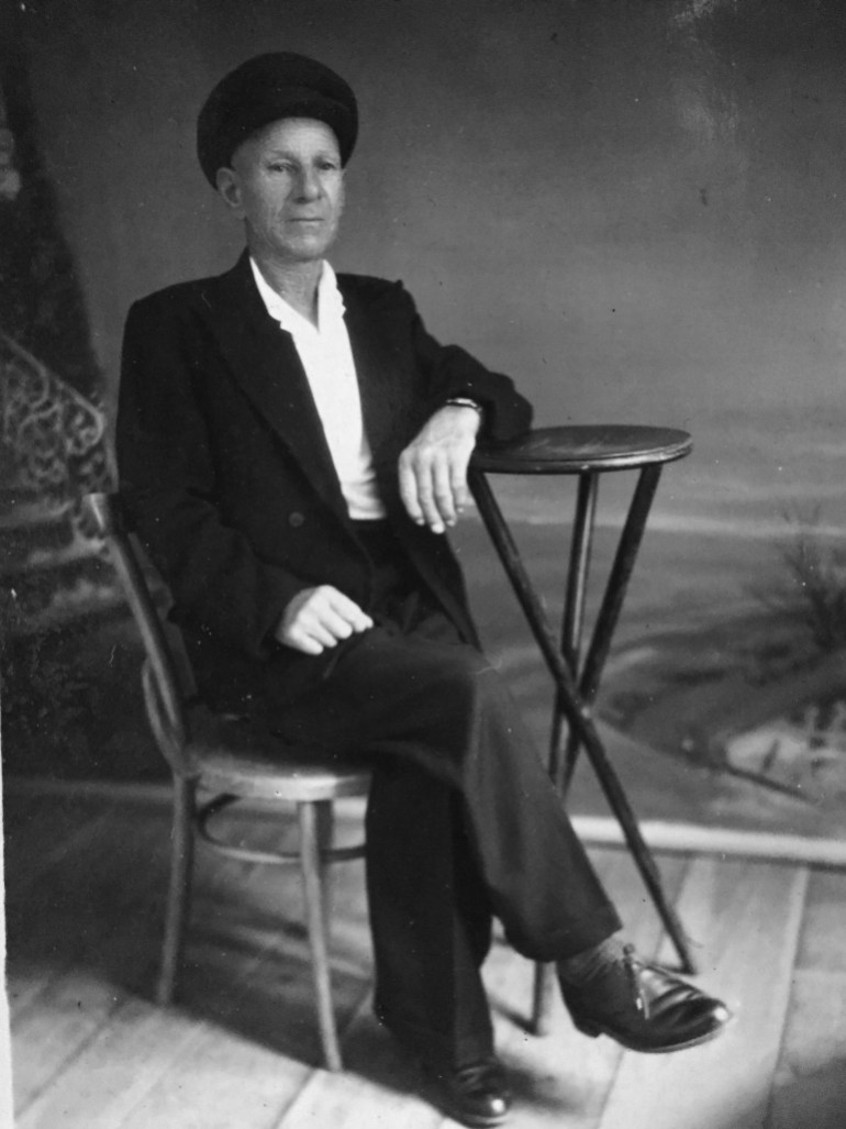 Black-and-white photo of Lara Dunston's great-grandfather seated at a small table with a fur hat on his head.