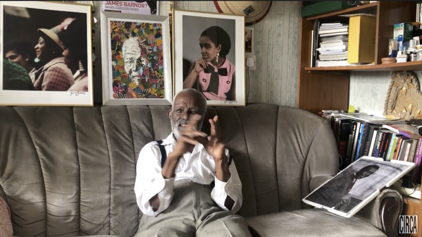 Photographer James Barnor sitting on a couch