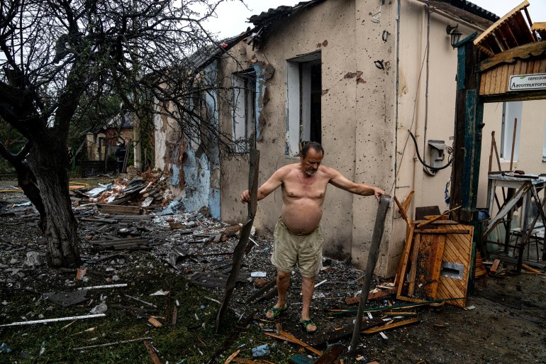 A man clears rubble from his house which was destroyed after a Russian attack in a residential neighbourhood in downtown Kharkiv, Ukraine.