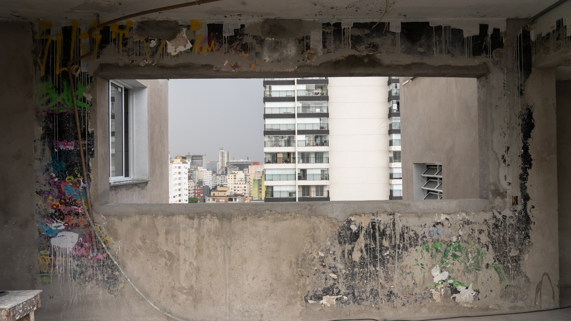 Remnants of graffiti painted during the occupation are seen against the backdrop of the city