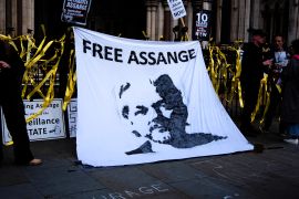 A banner with Julian Assange;s face on it and the words 'Free Assange'