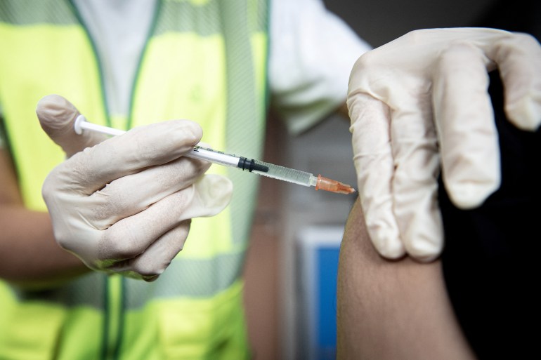 Close-up of a vaccine being administered in someone's arm.