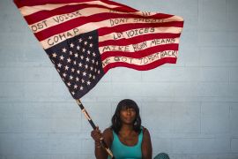 An activist waves an American flag upside down