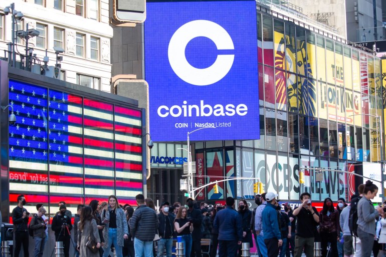 Monitors display Coinbase signage during the company's initial public offering (IPO) at the Nasdaq MarketSite in New York, U.S., on Wednesday, April 14, 2021. Coinbase Global Inc., the largest U.S. cryptocurrency exchange, is set to debut on Wednesday through a direct listing, an alternative to a traditional initial public offering that has only been deployed a handful of times.