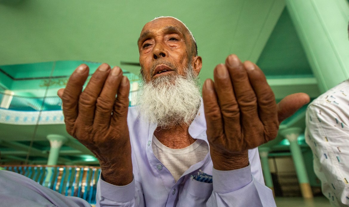 A Bangladeshi Muslim older man performs Eid al-Adha prayers at the Baitul Mukarram National Mosque in Dhaka,