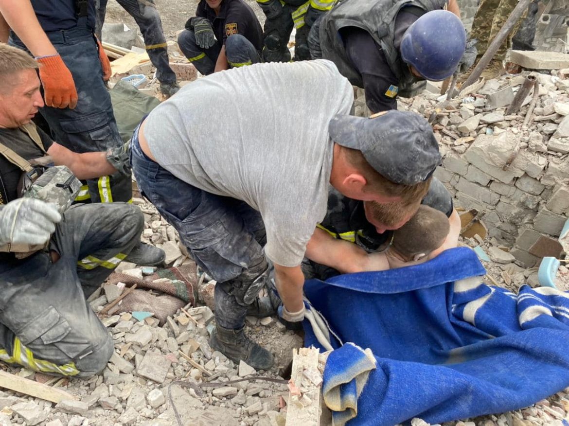 Rescuers pull a man from the rubble of a residential building damaged by a Russian military strike, in the town of Chasiv Yar