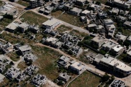 A picture taken by a drone shows buildings in Kafr Nabel, in Idlib province, stripped of their roofs and other construction materials [Al Jazeera]