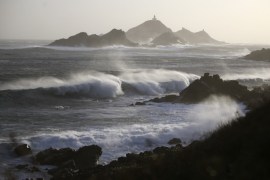 The Iles Sanguinaires&#39; lighthouse is pictured as strong winds and waves hit the coast on the island of Corsica [File: Pascal Pochard-Casabianca/AFP]