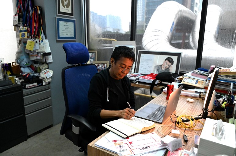 Rappler founder and journalist Maria Ressa working at her desk in the Rappler office in Manila