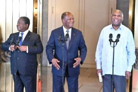 Ivory Coast President Alassane Ouattara (C) stands next to his predecessors Henri Konan Bedie (L) and Laurent Gbagbo (R) after a meeting at the presidential palace in Abidjan on July 14, 2022.