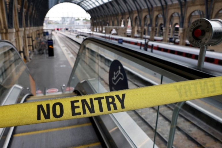 A No Entry belt barrier blocks access to a platform at King's Cross railway station in London