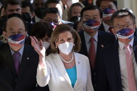 Visiting US House Speaker Nancy Pelosi (C) waves to journalists during her arrival at the Taipei parliament in Taipei on August 3, 2022 [Sam Yeh/AFP]