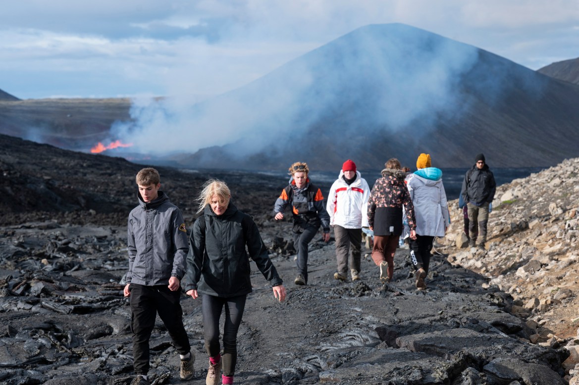 People visit the lava flow at the scene of the newly erupted volcano