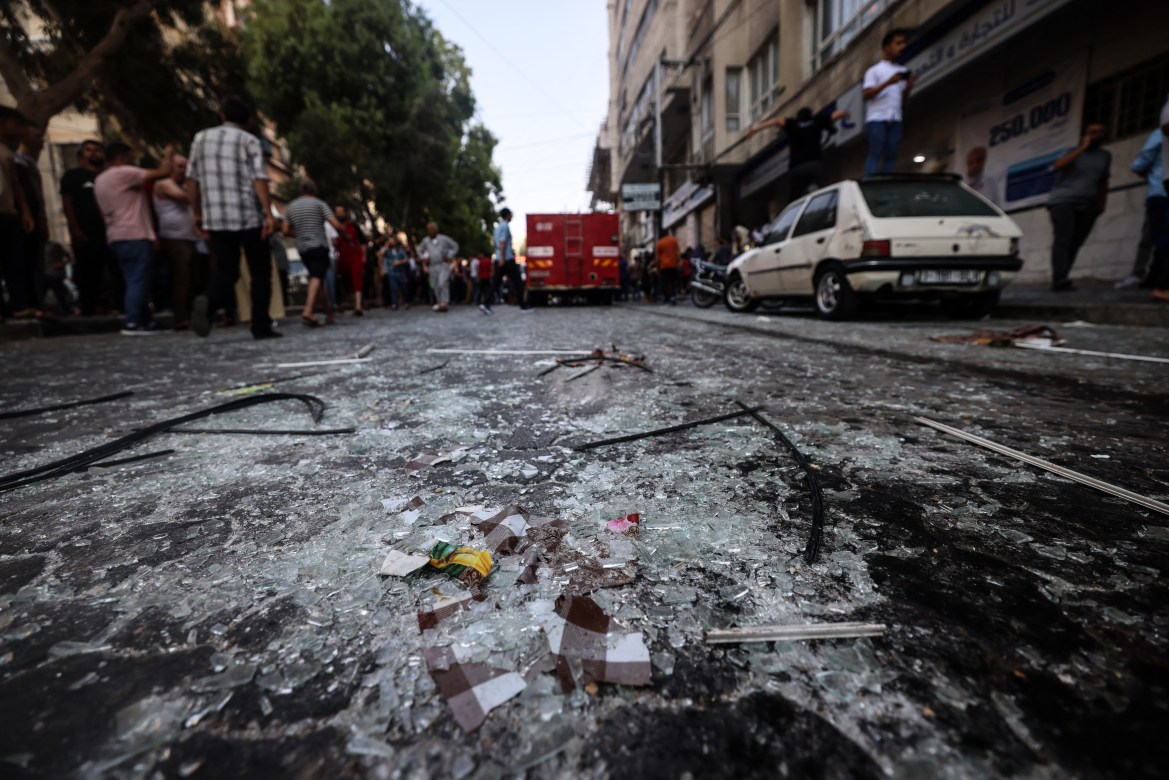 Shattered glass is scattered along a street in Gaza City.