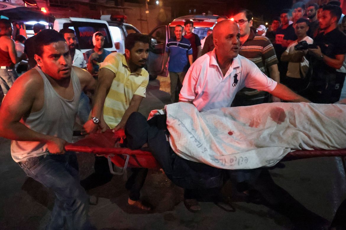 Palestinians transport the injured following a reported Israeli strike in Rafah