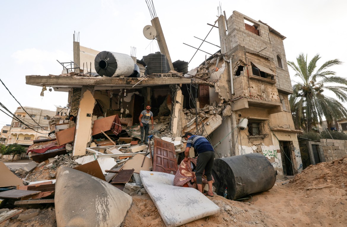 Palestinians salvage belongings from the rubble of their home