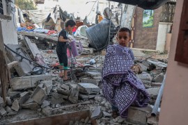 Palestinian children salvage their belongings from the rubble of their house in Gaza, which was destroyed during the latest three-day conflict with Israel [File: Said Khatib/AFP]