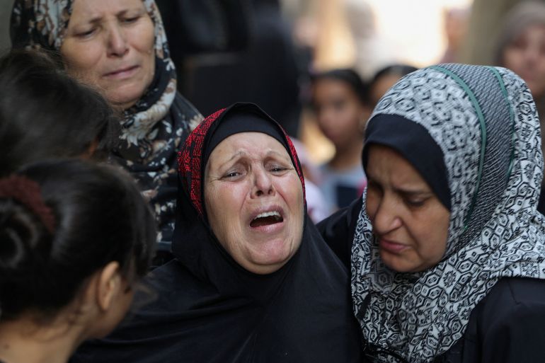 Relatives mourn during the funeral of four teenage Palestinians.